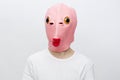 horizontal portrait of a man in a strange pink rubber mask