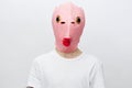 horizontal portrait of a man in a strange pink rubber mask