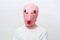 horizontal portrait of a man in a strange pink rubber mask