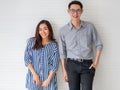 Horizontal portrait shot of young Asian lover couple wearing good-looking clothes, cross arms and looking at the camera with cute Royalty Free Stock Photo