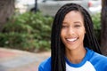 Horizontal portrait of smiling young african american woman outside