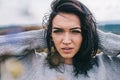 Horizontal portrait of young beautiful brunette woman posing against nature, meadow background with windy hair. People and Royalty Free Stock Photo