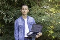 Horizontal portrait of young boy posing and looking at the camera holding a small drone with a portable camera Royalty Free Stock Photo