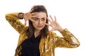 Horizontal portrait of a young glamorous girl in a gold sequined jacket