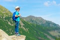 Horizontal portrait of a young traveler with a backpack high in