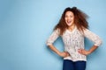 Portrait of young woman smiling against blue wall Royalty Free Stock Photo