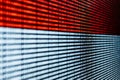 Horizontal red and white binary language over a screen background