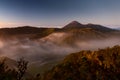 Horizontal shot of the beautiful Bromo volcano covered in fog under the clear sky