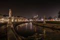 Horizontal shot of beautiful Italian statues reflected in the lake at night under the dark sky Royalty Free Stock Photo