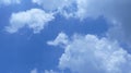 Horizontal shot of beautiful white puffy clouds in a clear blue sky Royalty Free Stock Photo