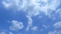 Horizontal shot of beautiful white puffy clouds in a clear blue sky Royalty Free Stock Photo