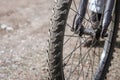 Bicycle wheel close-up against the background of a dirt road Royalty Free Stock Photo