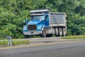 Blue Dump Truck On Divided Highway