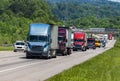 Blue Semi climbs Interstate Hill In Heavy Traffic Royalty Free Stock Photo