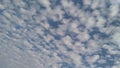 A horizontal shot of bright blue sky with puffy white clouds. Royalty Free Stock Photo