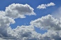 Horizontal shot of a bright blue sky with white puffy clouds. Royalty Free Stock Photo