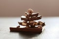 Horizontal shot of brown table with chocolate, handmade pyramide from chocholate pieces isolated over dark surface, milk Royalty Free Stock Photo