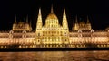 Horizontal shot of the Budapest Parliament building at night in front of the river Royalty Free Stock Photo