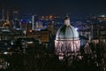 Horizontal shot a cityscape with a big dome on a church surrounded by green trees in Brescia