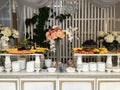 Horizontal shot of a fourchette table with plates and different fruits stacked on it Royalty Free Stock Photo
