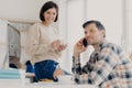 Horizontal shot of husband and wife analyze utilities bills, study bank loan documents, manage finances and plan expenses, make Royalty Free Stock Photo