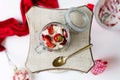 Horizontal shot of a jar of strawberries and white cream served on a square plate with a spoon Royalty Free Stock Photo