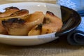 Horizontal shot of juicy baked quinces in a modern plate on a table