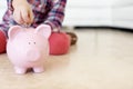 Start saving early-copyspace. Horizontal shot of a little girls hand putting coins in a piggybank.