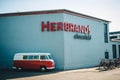 A horizontal shot of a nostalgic VW Bully in front of Herbrands in Cologne Ehrenfeld