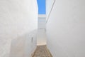 Horizontal shot of white alley narrowing in Andalusian old town