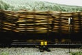 Horizontal shot of a railroad with a wall made out of wood in the back Royalty Free Stock Photo