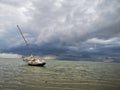 Horizontal shot of a sailboat in a sandbank in the Wangerooge island located in northern Germany Royalty Free Stock Photo