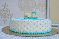 Custom made baby shower or first birthday cake for a boy with sleeping baby topper and cushion-like icing Royalty Free Stock Photo
