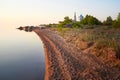 The shore of lake Peipus at sunset. Church of the apostles Peter and Paul in Vetvenik, Pskov region.