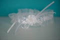 Silky white garter with flower detail and white pearly beads