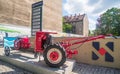 Horizontal shot of an simple vintage old red little tractor with two wheels