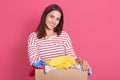 Horizontal shot of smiling brunette woman dresses striped casual shirt, looking directly ar camera with happy facial expression,