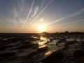 Horizontal shot of the sunrise reflected in the water under the beautiful sky Royalty Free Stock Photo