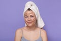 Horizontal shot of teenage girl cleaning her face with coffee scrub, young age female having some difficulties with fece, doing Royalty Free Stock Photo