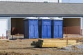 Three Porta Potties Or Outdoor Toilets At New Construction Site
