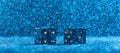 Two black dices on a blue bokeh background. The concept of gambling. Royalty Free Stock Photo