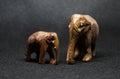 Horizontal shot of two elephant sculptures with a grey blurry background