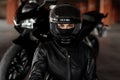 Horizontal shot of unrecognizable woman motorcycle rider driving her enduro motobike or chopper dressed in stylish Royalty Free Stock Photo