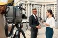 Journalism that is independent, honest, and dignified. Cameraman and news reporter interviewing politician. Journalism