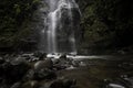 Horizontal shot of a waterfall surrounded by vegetation in the middle of the humid tropical jungle of Costa Rica Royalty Free Stock Photo