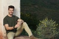 Horizontal shot of a young male with a charming wide smile enjoying the nature