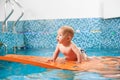 Baby having fun in the swimming pool