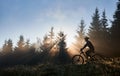 Young man riding bicycle in the mountains in early morning