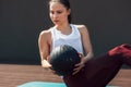 Horizontal sporty young woman doing exercises with a medicine ball outdoors on a sunny day. Fitness female exercising fitness ball Royalty Free Stock Photo