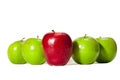 Straight On shot of a Big Red Apple Standing Tall in Front of Four Green Apples